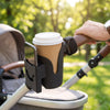 Black Bumpwell stroller cup and phone holder on a handlebar with a coffee cup and smartphone