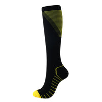 Black knee-high compression sock with yellow accents, side view