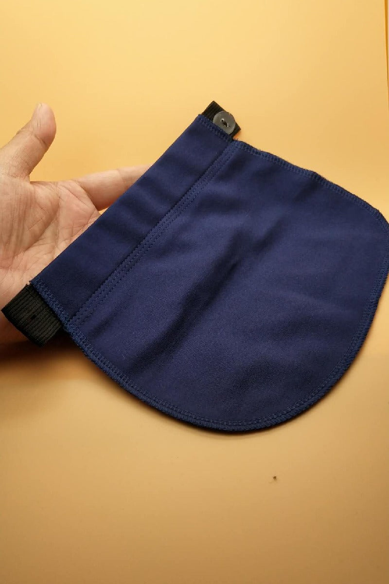 Navy pants extender held in a hand