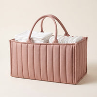 Dusty pink Bumpwell quilted diaper caddy organizer with carry handles