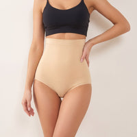 Woman wearing the beige Bumpwell seamless high-waist postpartum brief