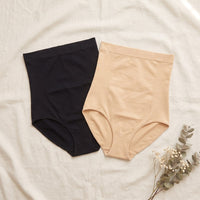 Black and beige Bumpwell high-waist briefs laid flat side by side