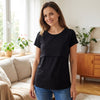 Woman wearing the black Bumpwell nursing T-shirt with a double-layer front and jeans