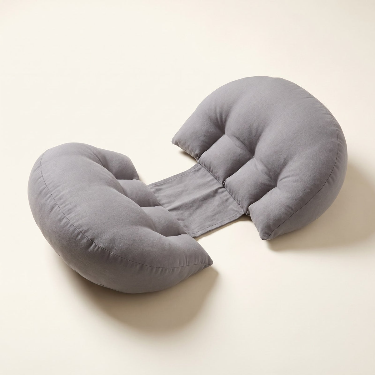 Grey Bumpwell pregnancy wedge pillow with two half-moon cushions joined by a fabric band