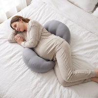 Top view of a pregnant woman side sleeping with the Bumpwell two-sided wedge pillow