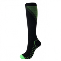 Black knee-high compression sock with green accents, side view