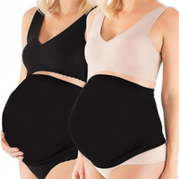Two pregnant women wearing the seamless belly band, one in black and one in nude