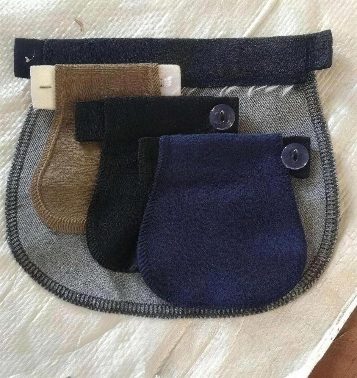 Three maternity pants extenders in beige, black and navy