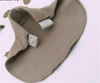 Beige pants extender showing the elastic strap and buttonhole