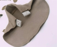Beige pants extender showing the elastic strap and buttonhole